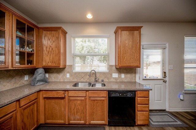 4609 Buescher Ct, Pearland, TX 77584 - kitchen featuring black dishwasher, backsplash, glass insert cabinets, and a sink