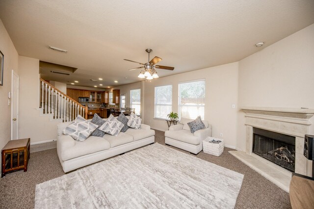 4609 Buescher Ct, Pearland, TX 77584 - carpeted living area featuring recessed lighting, stairway, a fireplace, ceiling fan, and baseboards