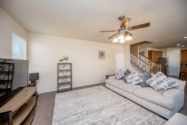 4609 Buescher Ct, Pearland, TX 77584 - living area with baseboards, a ceiling fan, stairs, and carpet flooring
