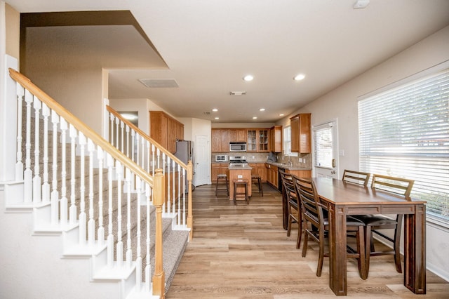 4609 Buescher Ct, Pearland, TX 77584 - dining room with visible vents, light wood-type flooring, stairway, and recessed lighting