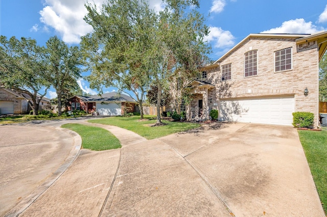 4609 Buescher Ct, Pearland, TX 77584 - view of front of property with brick siding, a front yard, concrete driveway, and an attached garage