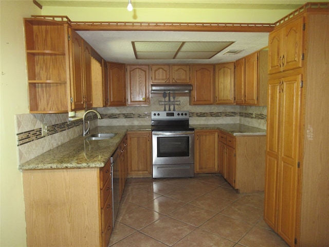 kitchen featuring appliances with stainless steel finishes, decorative backsplash, sink, and light stone counters