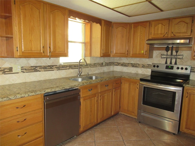 kitchen with dishwasher, tile patterned flooring, sink, light stone countertops, and stainless steel electric range