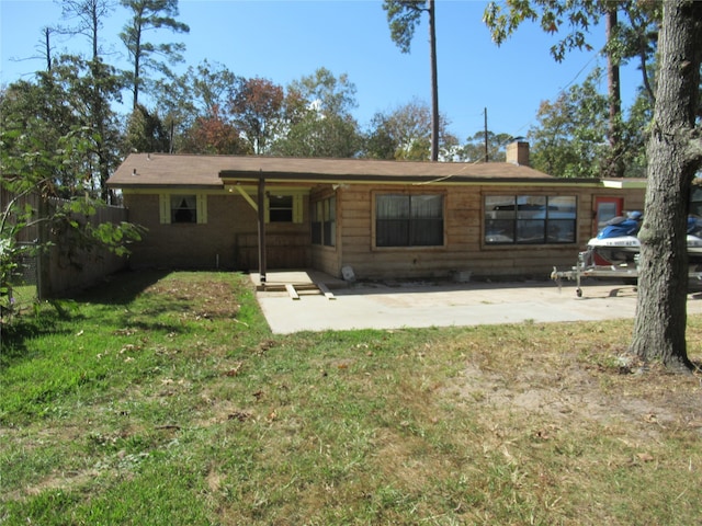 rear view of property with a patio area and a lawn