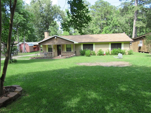372 Creekside Dr, Onalaska, TX 77360 - ranch-style house featuring a chimney, a porch, and a front yard
