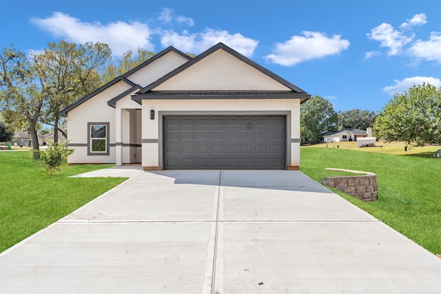 view of front of property featuring a front yard and a garage