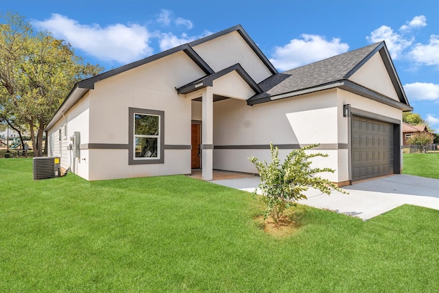 view of front of property featuring a front lawn, a garage, and cooling unit