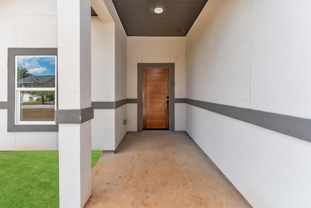 doorway to property featuring a lawn