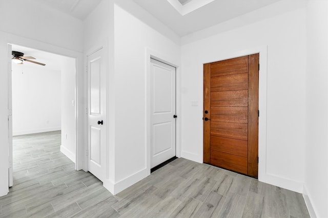 hallway with light hardwood / wood-style floors