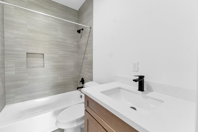 full bathroom featuring toilet, tiled shower / bath combo, and vanity