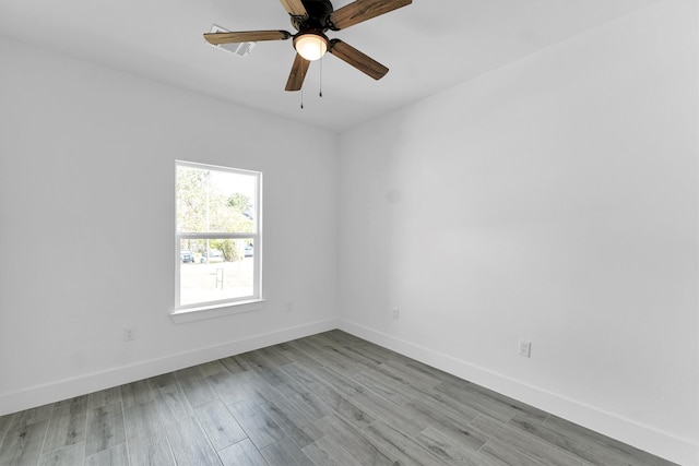 empty room with ceiling fan and light hardwood / wood-style flooring