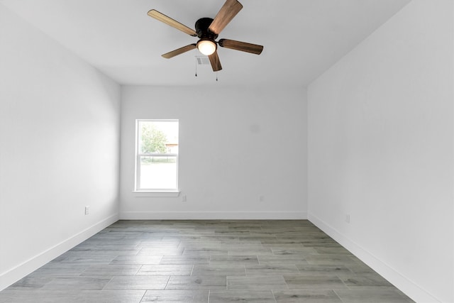 spare room with light hardwood / wood-style flooring and ceiling fan