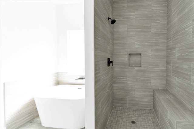 bathroom with shower with separate bathtub