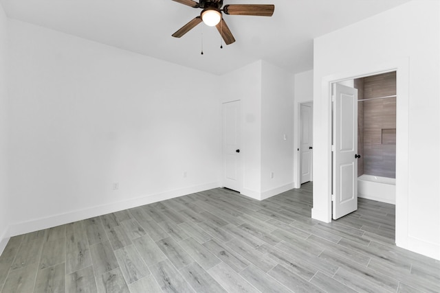 unfurnished bedroom with ensuite bathroom, ceiling fan, and light hardwood / wood-style flooring