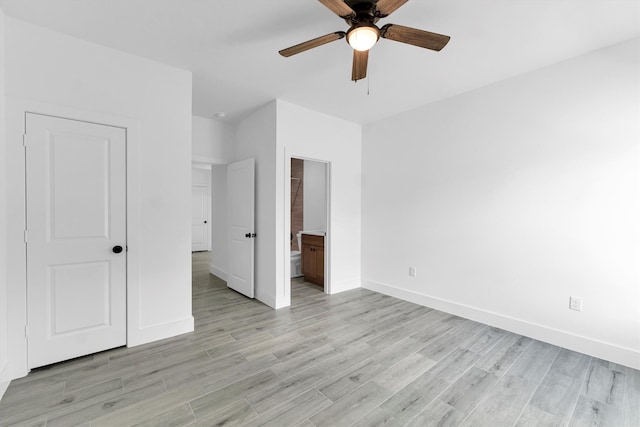 unfurnished bedroom featuring light hardwood / wood-style floors, ceiling fan, and connected bathroom