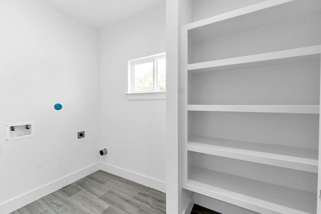 clothes washing area with light wood-type flooring, electric dryer hookup, and washer hookup