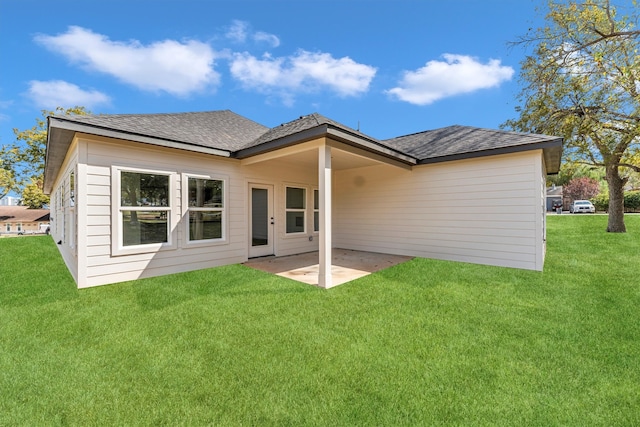 rear view of house with a lawn and a patio area