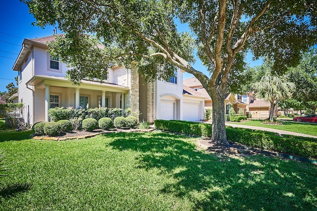 view of front of house with a front yard and a garage