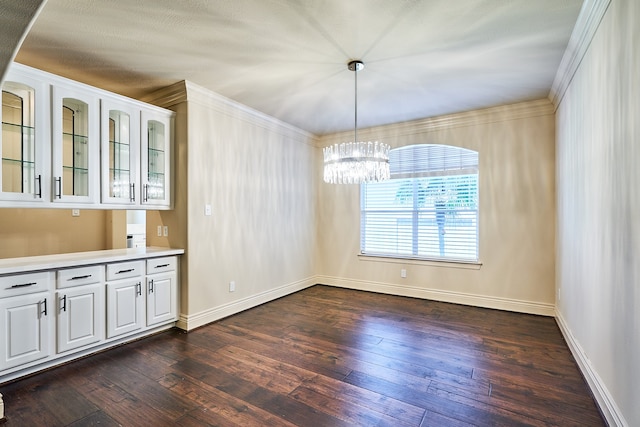 unfurnished dining area featuring crown molding, a notable chandelier, and dark hardwood / wood-style flooring