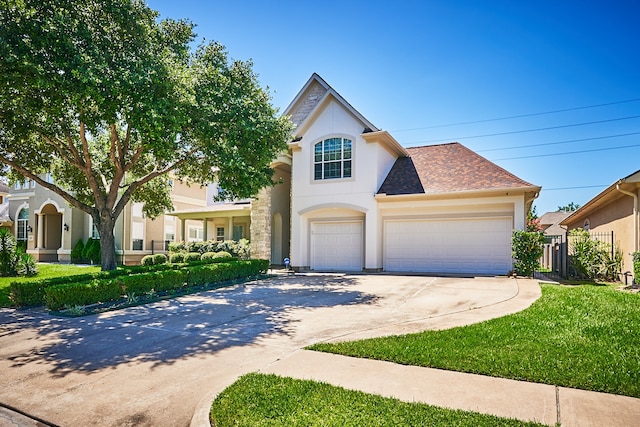 view of front of property featuring a front yard and a garage