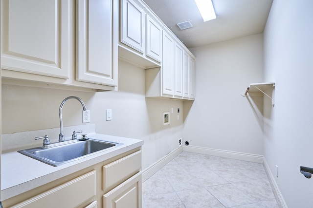 laundry area with cabinets, light tile patterned floors, hookup for a washing machine, electric dryer hookup, and sink