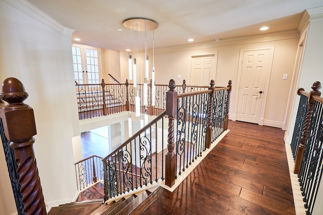 stairway with ornamental molding and hardwood / wood-style flooring