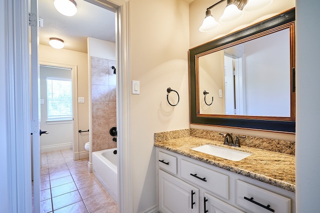 full bathroom with vanity, tiled shower / bath, toilet, and tile patterned floors