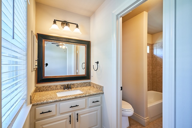 full bathroom featuring toilet, ceiling fan, tile patterned floors, tiled shower / bath, and vanity