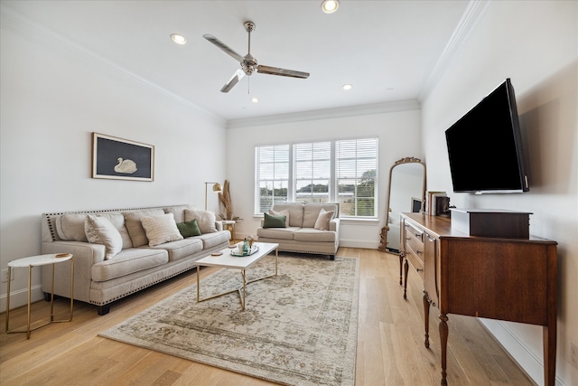 living room with crown molding, light hardwood / wood-style flooring, and ceiling fan