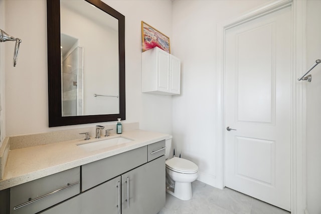 bathroom featuring toilet, vanity, and a shower