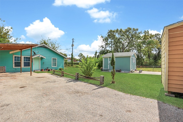 exterior space featuring a yard and a storage shed