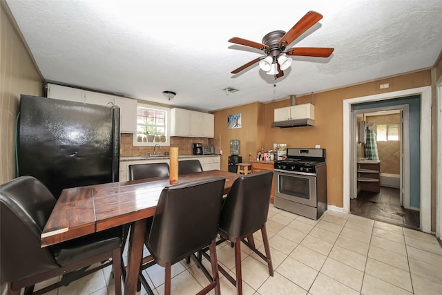 interior space featuring sink, a textured ceiling, and light tile patterned floors