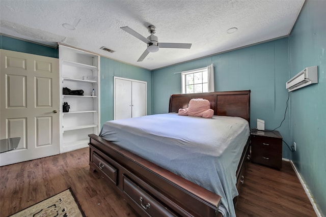 bedroom featuring a textured ceiling, dark hardwood / wood-style floors, and ceiling fan