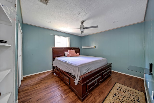 bedroom featuring crown molding, a textured ceiling, dark wood-type flooring, and ceiling fan