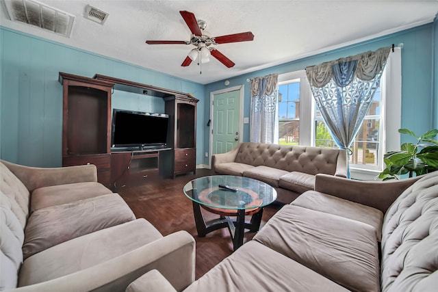 living room with ceiling fan, a textured ceiling, and dark hardwood / wood-style flooring