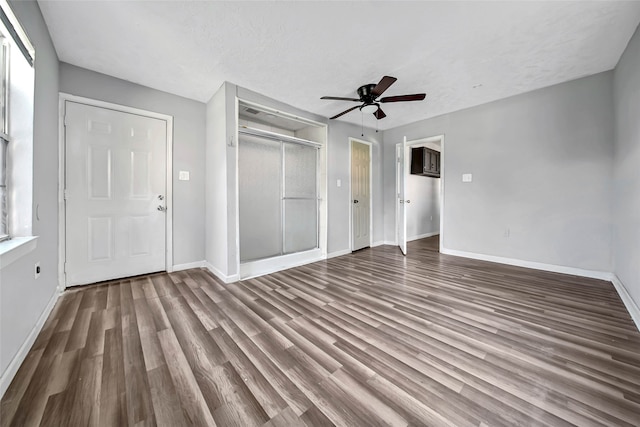 interior space featuring ceiling fan, hardwood / wood-style flooring, and a textured ceiling