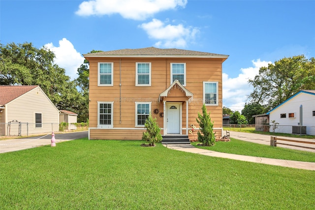 view of front of home featuring a front yard and cooling unit