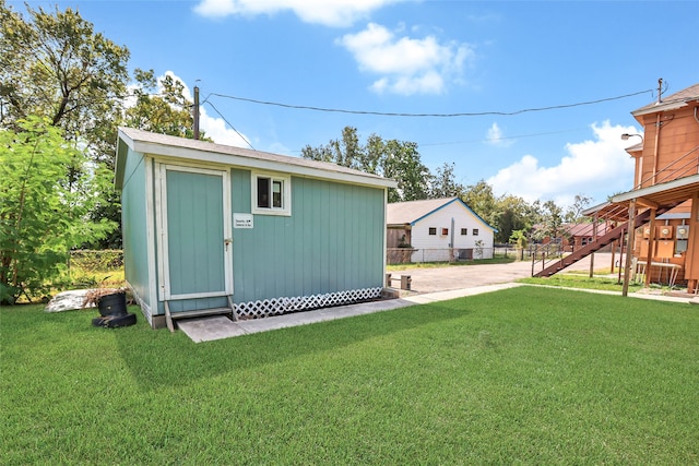 view of outbuilding with a lawn