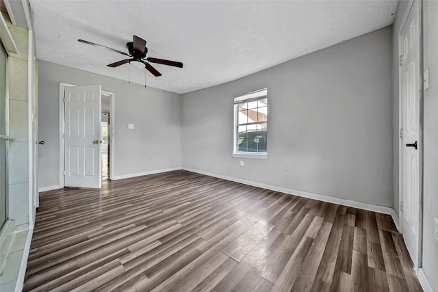 unfurnished room with a textured ceiling, wood-type flooring, and ceiling fan