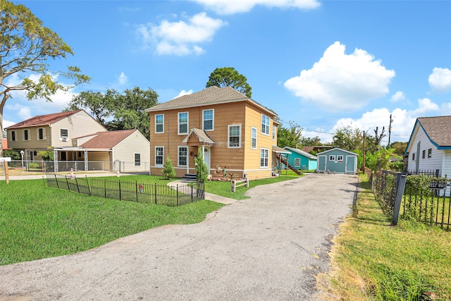 view of front of property featuring a shed and a front lawn