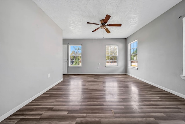 unfurnished room featuring a textured ceiling, dark wood-type flooring, and ceiling fan