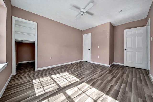 unfurnished bedroom with a textured ceiling, dark hardwood / wood-style floors, a closet, and ceiling fan