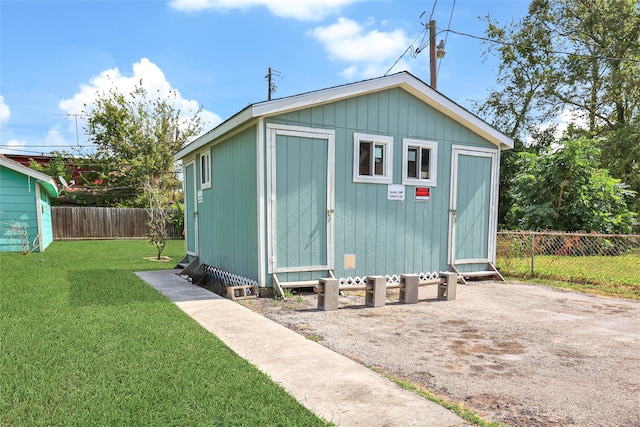 view of outbuilding with a lawn