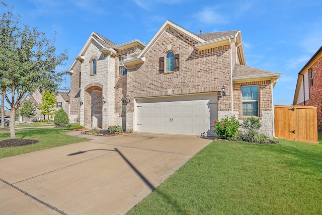 view of front of home with a front lawn and a garage