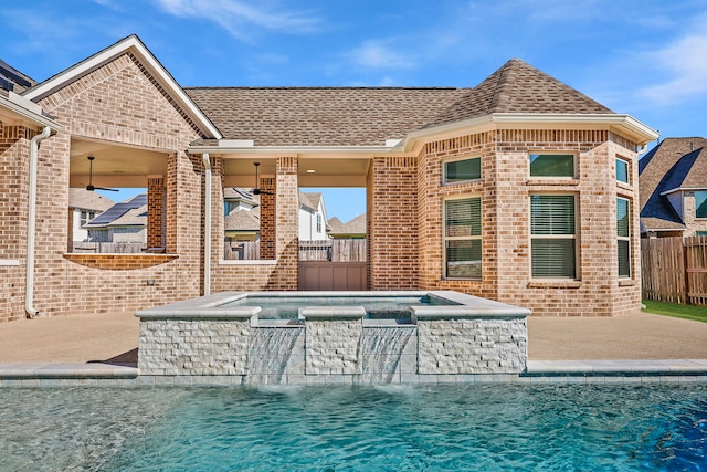 view of pool with a patio, pool water feature, an in ground hot tub, and ceiling fan