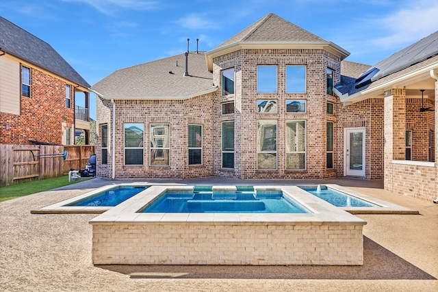 view of swimming pool featuring an in ground hot tub and a patio