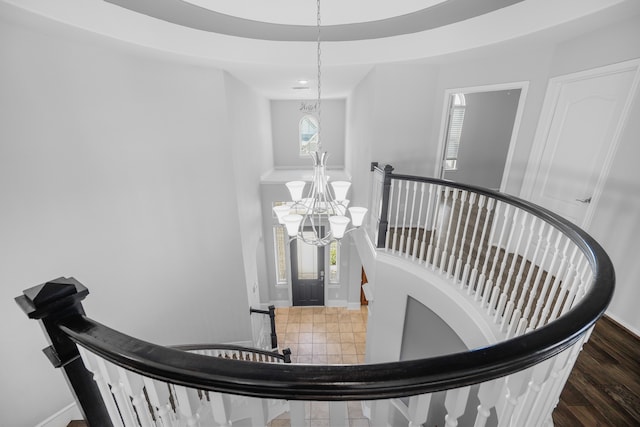 stairway featuring a chandelier and hardwood / wood-style flooring