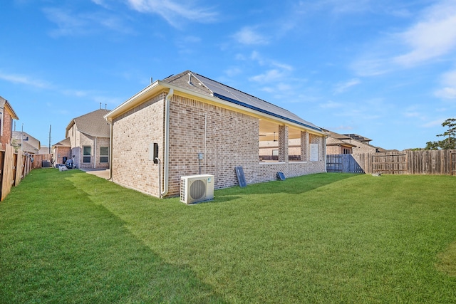 back of house featuring a lawn and ac unit