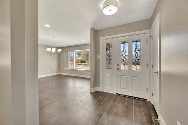 entrance foyer with a chandelier and dark hardwood / wood-style flooring