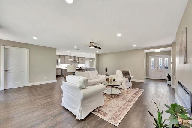 living room featuring hardwood / wood-style flooring and ceiling fan